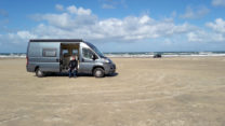 Op het strand, met de schuifdeur van de wind af. Het waait hier behoorlijk!